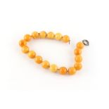 Property of a lady - a good butterscotch amber bead necklace, the eighteen large uniform beads