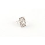 An Art Deco style 18ct white gold diamond pierced rectangular panel ring, the centre stone