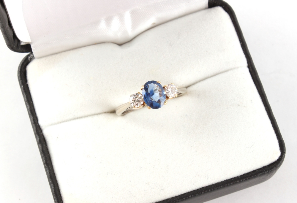 An 18ct white gold sapphire & diamond three stone ring, the oval cushion cut sapphire weighing - Image 2 of 2