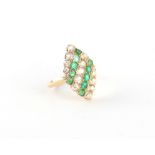 An unmarked yellow gold emerald & diamond ring, the marquise shaped panel set with alternating