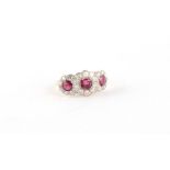 An 18ct yellow gold ruby & diamond triple cluster ring, size M.