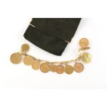 Property of a lady - a gold coin charm bracelet, the clasp tongue stamped 750 (tests 18ct), the