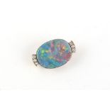 An unmarked high carat yellow gold black opal & diamond brooch, 30mm wide.