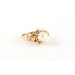 A 14ct yellow gold single pearl ring, in ornate claw setting, approximately 3.6 grams, size L/M.