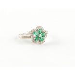 Property of a deceased estate - a 14ct white gold emerald & diamond flowerhead cluster ring, with