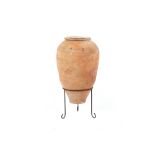 A Turkish terracotta olive or water jar, on stand, 31.5ins. (80cms.) high (overall).