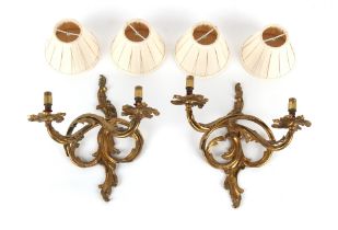 Property of a lady - a pair of French ormolu rocaille twin wall lights, 13ins. (33cms.) high (2).