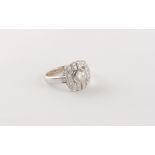 An Art deco style white gold or platinum diamond ring, the round brilliant cut centre stone weighing