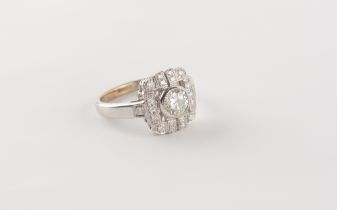 An Art deco style white gold or platinum diamond ring, the round brilliant cut centre stone weighing