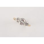 An 18ct yellow gold diamond three stone ring, the centre round brilliant cut diamond weighing