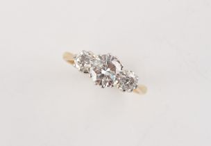An 18ct yellow gold diamond three stone ring, the centre round brilliant cut diamond weighing