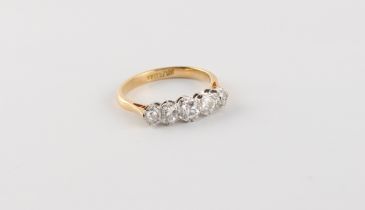 An 18ct yellow gold diamond five stone ring, the five round brilliant cut diamonds weighing an