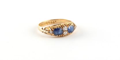 Property of a lady - an early 20th century 18ct gold sapphire & diamond ring, the two oval cushion