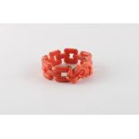 A coral link bracelet with carved bird & snake clasp, with safety chain, approximately 34.4 grams.