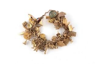 Property of a gentleman - a 9ct gold charm bracelet, with 48 charms including an 1859 American