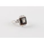 An Art Deco style platinum or white gold black onyx & diamond ring, the head measuring approximately