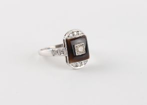 An Art Deco style platinum or white gold black onyx & diamond ring, the head measuring approximately