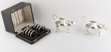 Property of a lady - a cased pair of silver toast racks; together with a pair of silver