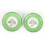 Property of a lady - a pair of Chinese Canton enamel European subject circular dishes, late Qing