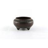 An 18th century Chinese bronze tripod censer with decorative relief band, 3-character mark to