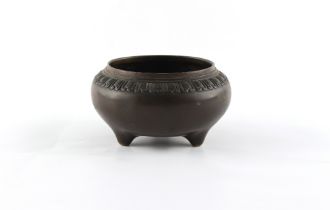 An 18th century Chinese bronze tripod censer with decorative relief band, 3-character mark to