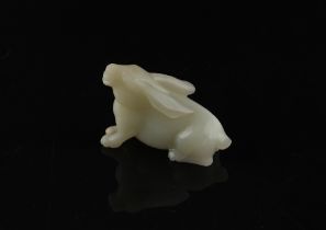 A Chinese carved white jade model of a Rabbit, probably 20th century, 3ins. (7.6cms.) long, 2.