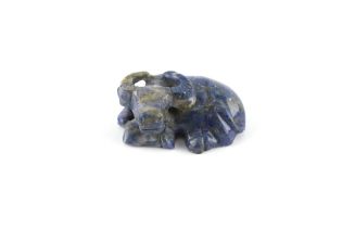 A Chinese carved lapis lazuli model of a Recumbent Buffalo, 2.2ins. (5.6cms.) long.
