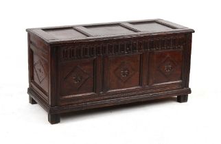 Property of a lady - a 17th century carved oak coffer, 48.4ins. (123cms.) long (overall).