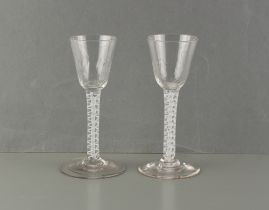 Two similar opaque airtwist stem glasses, 18th / 19th century, with softly moulded bowls, 5.