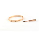 Property of a lady - Cartier - an 18ct rose gold 'Love' bracelet or bangle, set with four round