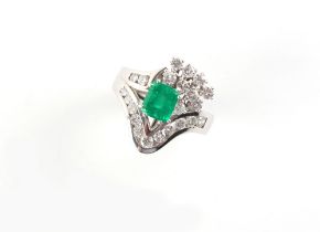 Property of a gentleman - an 18ct white gold emerald & diamond ring, the octagonal cut emerald