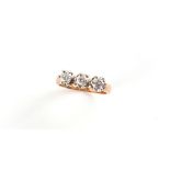 Property of a lady - a Continental gold (tests approximately 15ct) diamond three stone ring, the