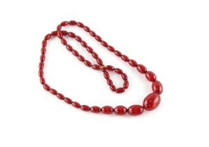 Property of a lady - a cherry amber type graduated bead necklace, approximately 54.3 grams.