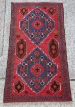 Property of a gentleman - an Afghan hand-knotted wool rug with red ground, 74 by 40ins. (188 by