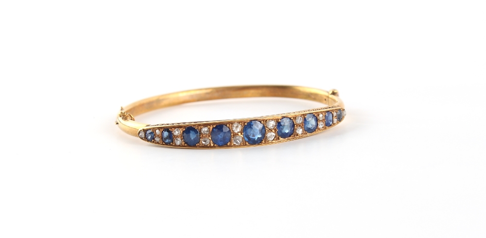 A late Victorian yellow gold (tests 15ct) sapphire & diamond hinged bangle, the nine well matched - Image 2 of 2