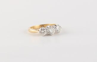 An 18ct yellow gold diamond three stone ring, the estimated total diamond weight 1.05 carats, size