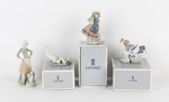 Property of a lady - four Lladro figures, the tallest 9.25ins. (23.5cms.) high (three in original