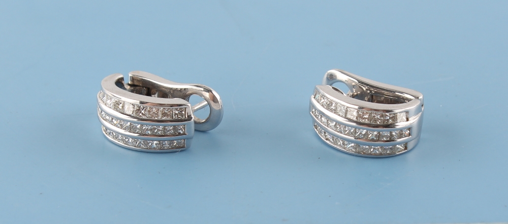 A pair of 18ct white gold diamond half hoop earrings, each set with three rows of diamonds, with
