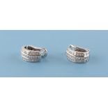 A pair of 18ct white gold diamond half hoop earrings, each set with three rows of diamonds, with