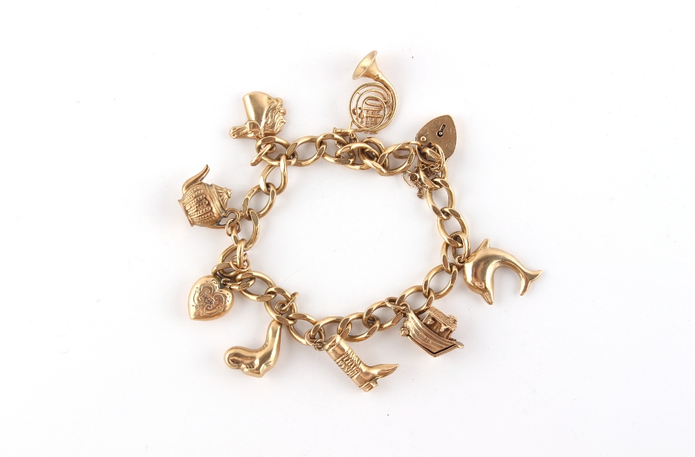 Property of a lady - a 9ct gold charm bracelet with eight 9ct gold charms including a French horn,