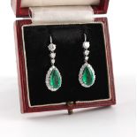 A good pair of emerald & diamond pendant earrings, the two pear shaped cut emeralds of vivid