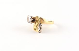 Property of a deceased estate - a modern yellow gold (tests 18ct) diamond ring, the larger round