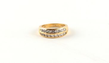 Property of a lady - an 18ct yellow gold ring set with two rows of nine round brilliant cut