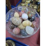 Seventeen Mineral Eggs, including a painted example, in glass bowl.