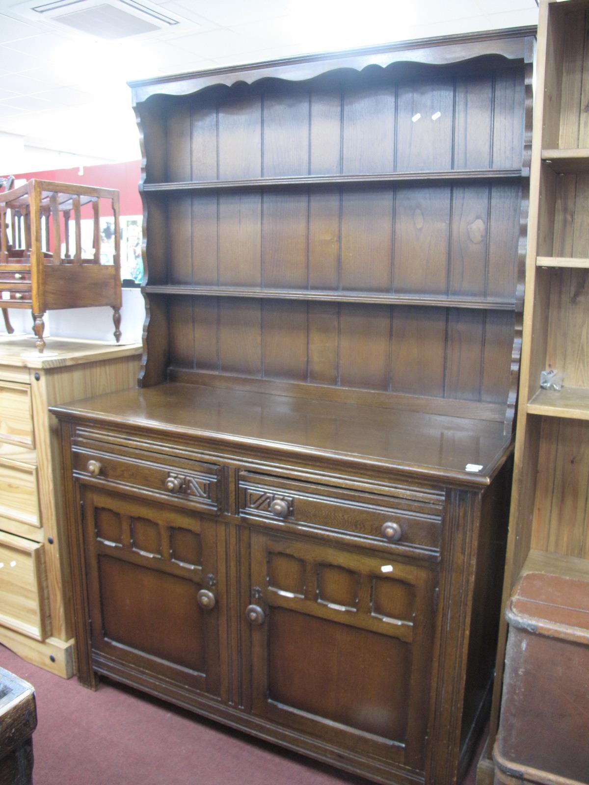 A XX Century Oak Dresser, rack with three shelves, panelled back, base with two drawers over twin