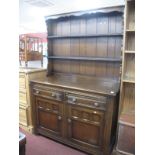 A XX Century Oak Dresser, rack with three shelves, panelled back, base with two drawers over twin