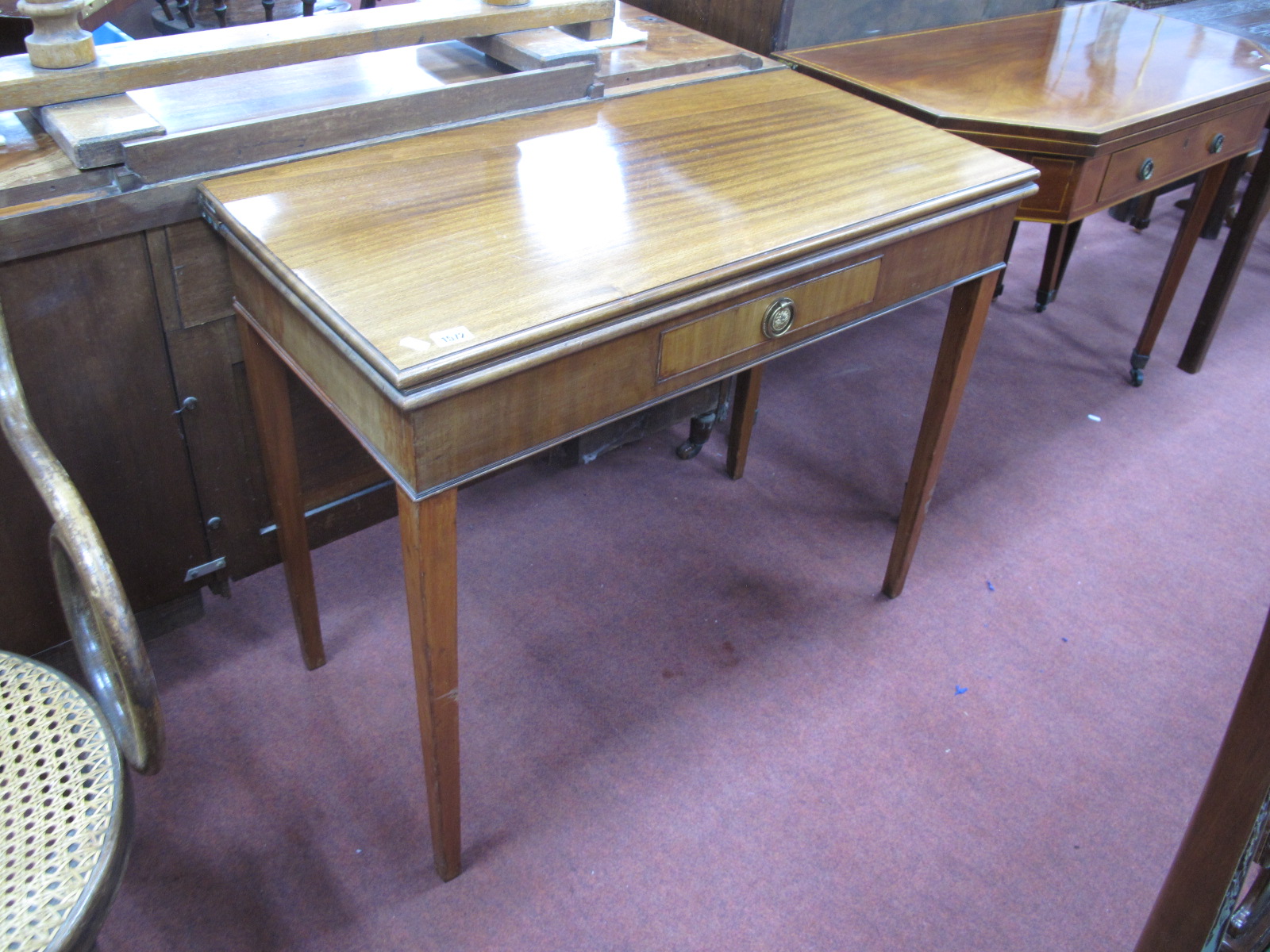 An Early XIX Century Mahogany Tea Table, with a fold over top, single drawer, on tapering legs, 91cm