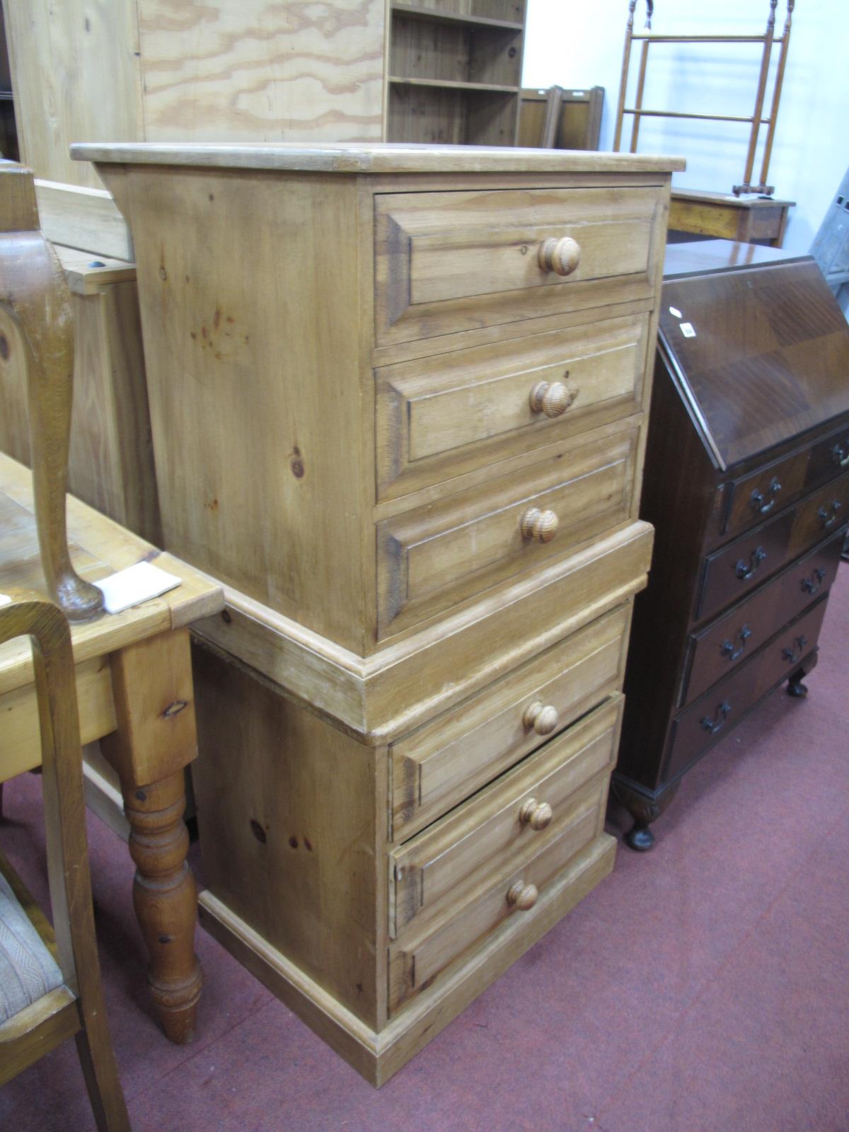 A Pair of Pine Bedside Chests, with three small drawers, on plinth bases, 61cm wide.