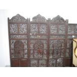 A Late XIX/Early XX Century Indian Hardwood Four Fold Screen, decorated with figures, animals and