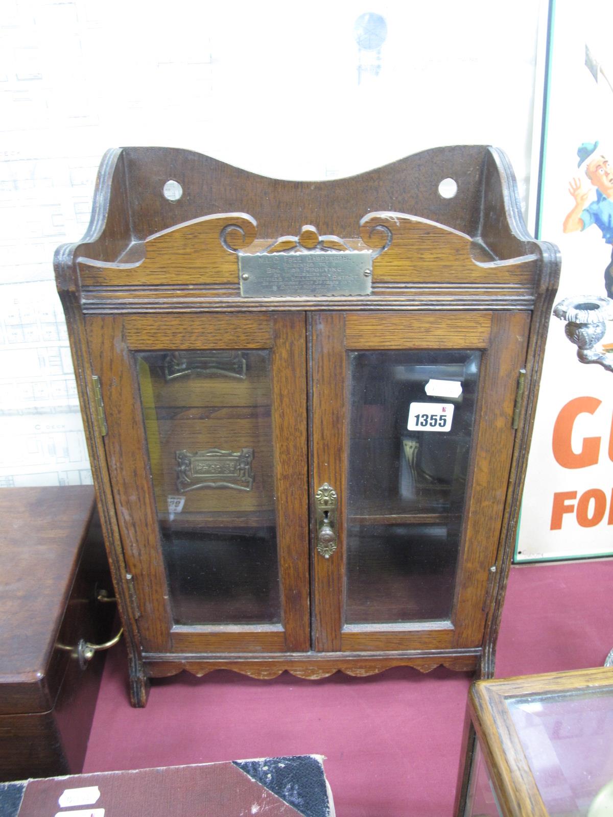 An Early XX Century Oak Smoker's Wall Cabinet, with twin glazed bevelled glass doors, two internal